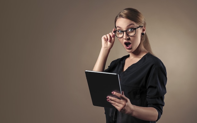 Woman with glasses holding digital tablet