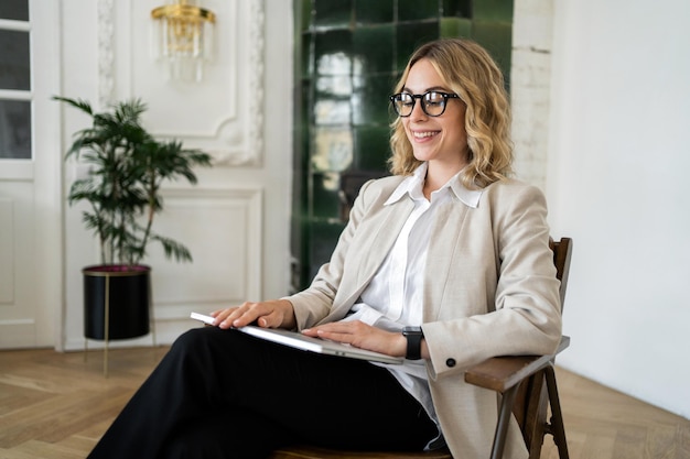 A woman with glasses is a marketing expert working in an office