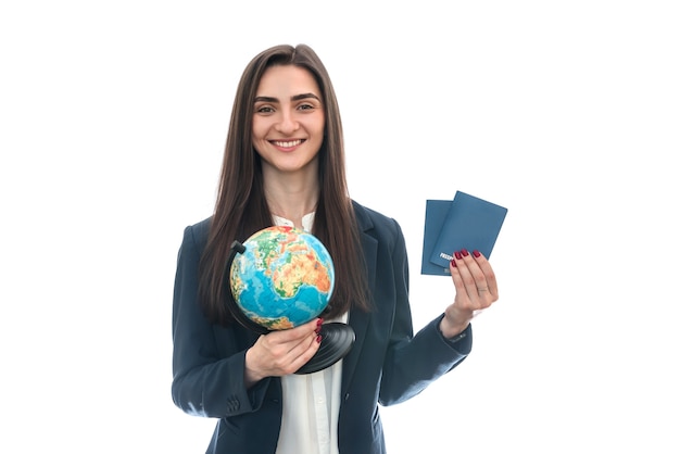 Woman with globe and passports isolated on white