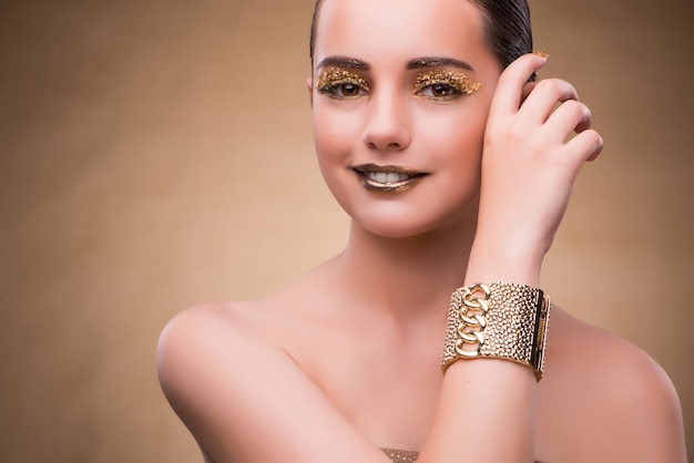 Woman with golden bracelet in beauty concept