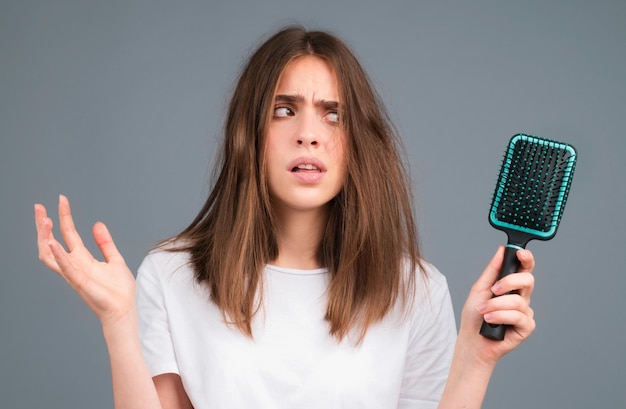 Woman with hair loss problem Portrait of Young girl with a bald Head shot of a nervous girl with a hairbrush