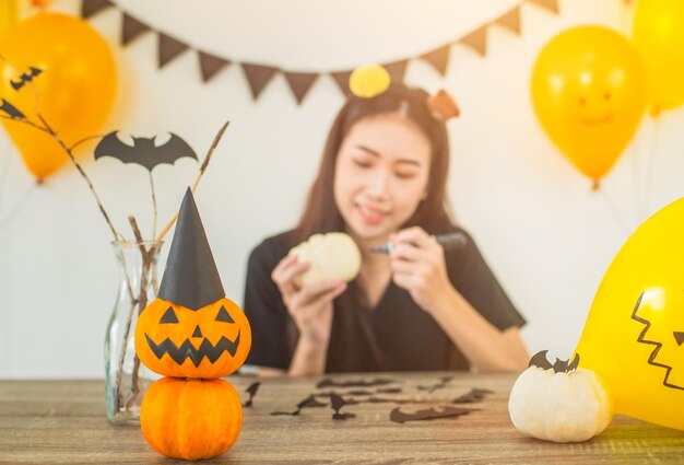 Woman with halloween decorations at table