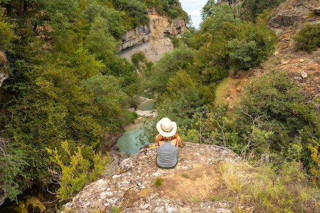 A woman with a hat enjoying the peace of nature in the Pyrenees Panticosa