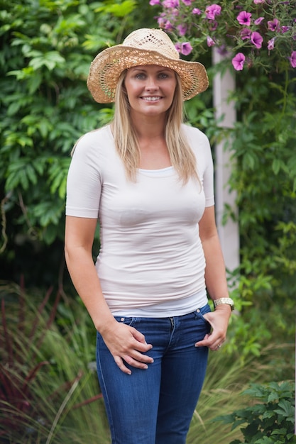 Woman with a hat in the garden