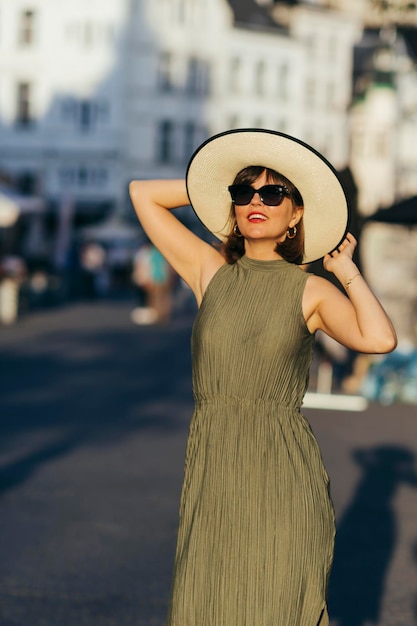 Woman with hat walking in city on a sunny day