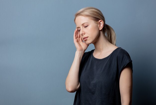 Woman with headache on grey space