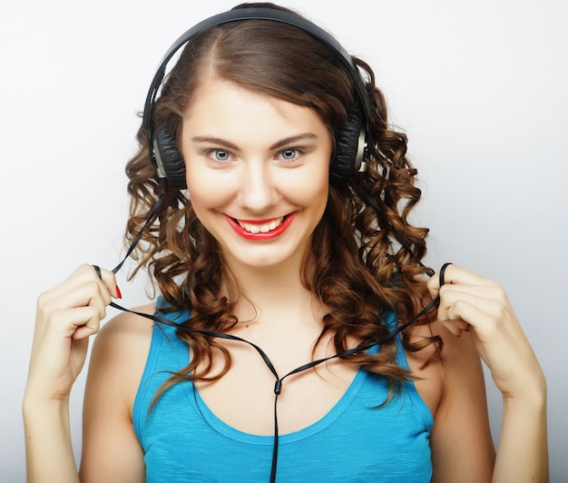 Woman with headphones listening music. Music  girl dancing against isolated white background