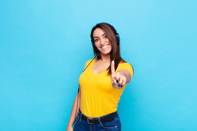 woman with headphones making number one pose