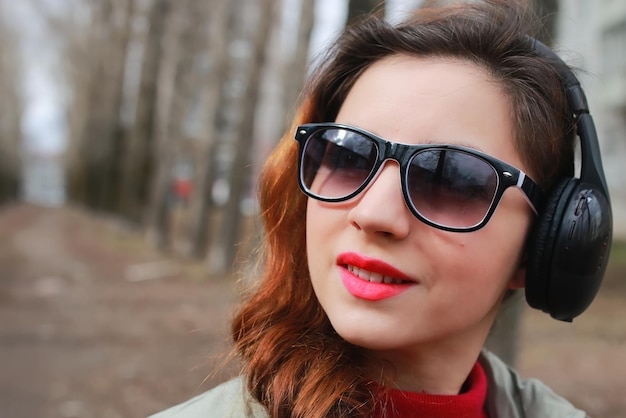 Woman with headphones in park autumn