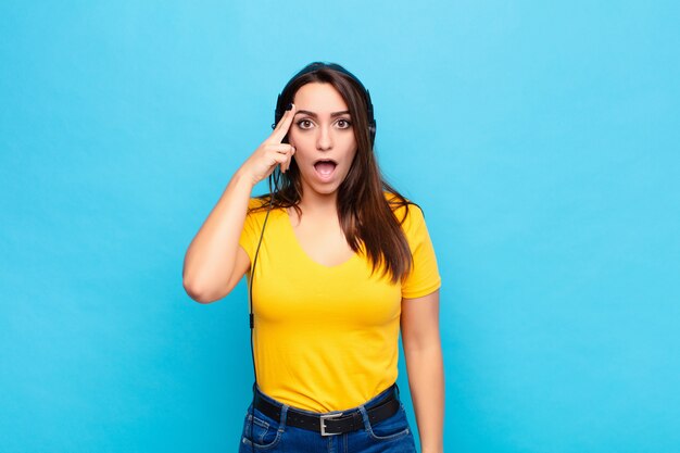 woman with headphones realizing a new thought