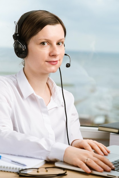 Woman with headset working in office to solve problems