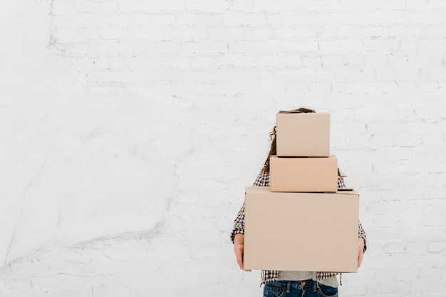 Woman with heap of boxes