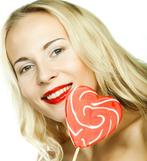 Photo woman with heart lolly pop