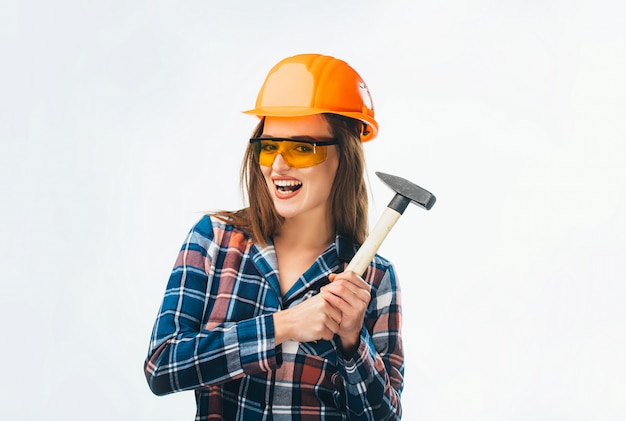 woman with helmet holding hammer