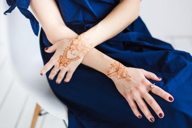 woman with henna drawing on hands, mahendi