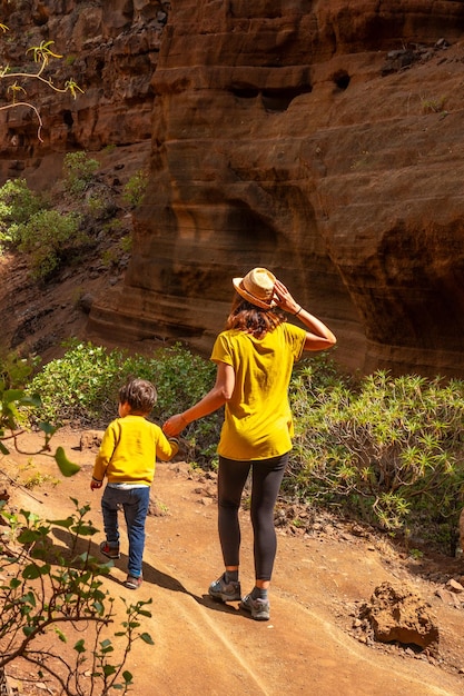 A woman with her child in the limestone canyon Barranco de las Vacas on Gran Canaria Canary Islands