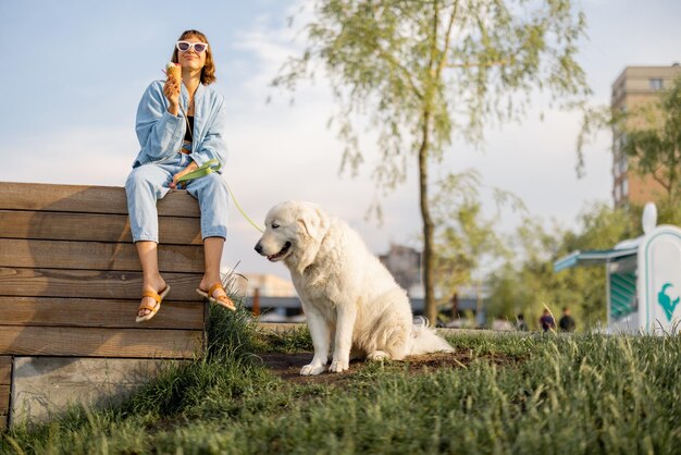 Woman with her dog near lake in park