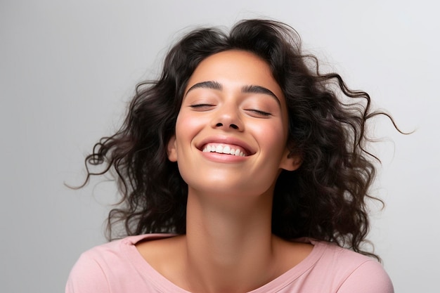 A woman with her eyes closed smiles and her eyes closed.