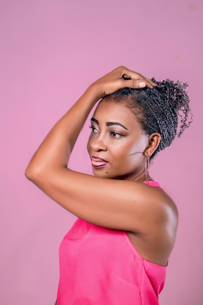 a woman with her hair in a pink top