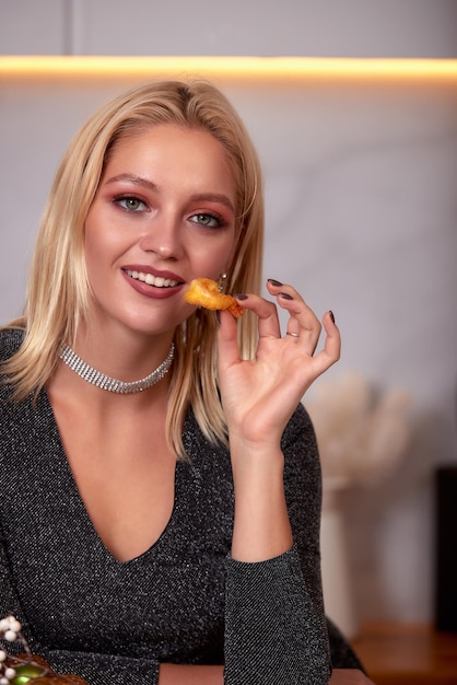 A woman with her hands eats a large appetizing shrimp Selective focus