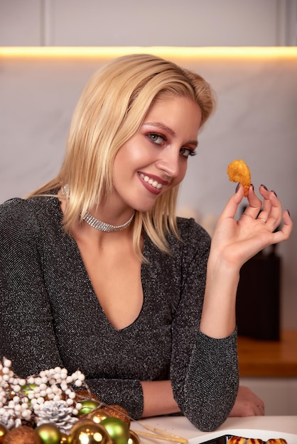 A woman with her hands eats a large appetizing shrimp Selective focus