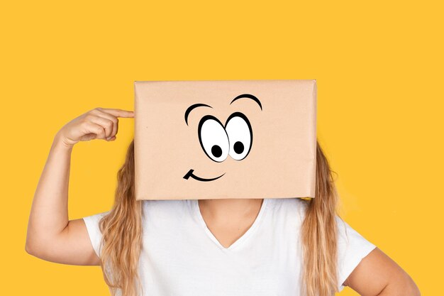 Woman with her head in a box with madness gesture standing on a white background with copy space