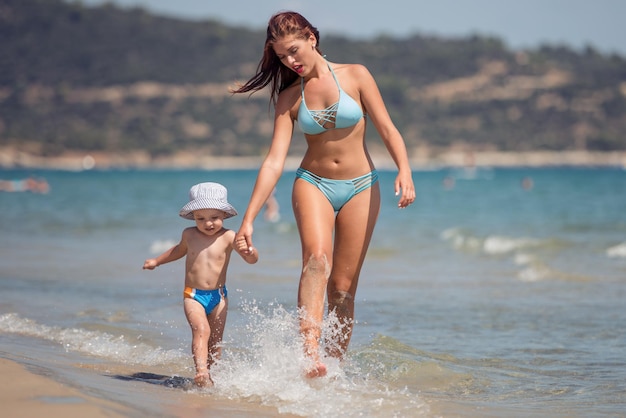 Woman with her son on the beach