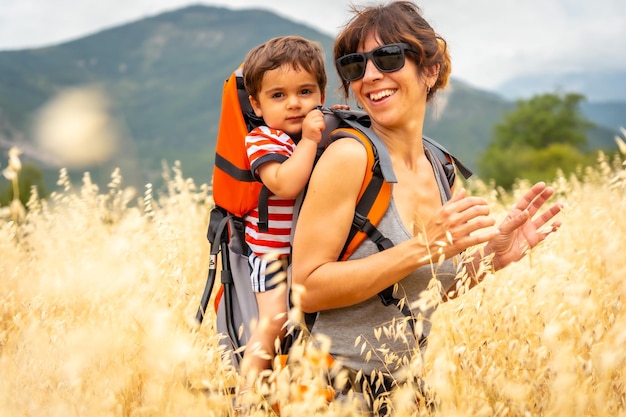 A woman with her son in a field of yellow wheat grain ready for harvest enjoying vacations