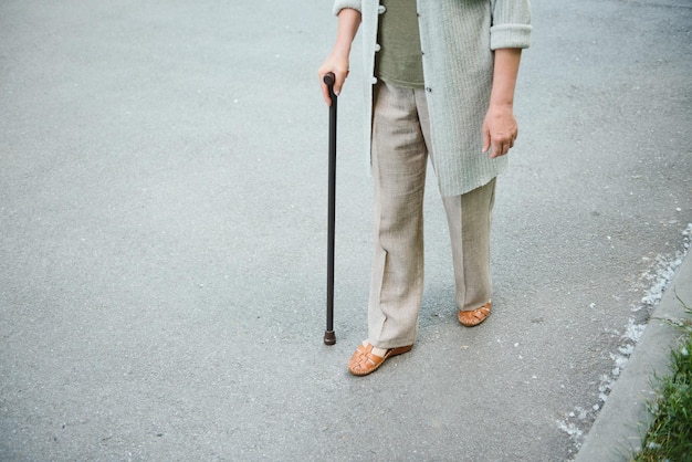 Woman with her walking stick in the park