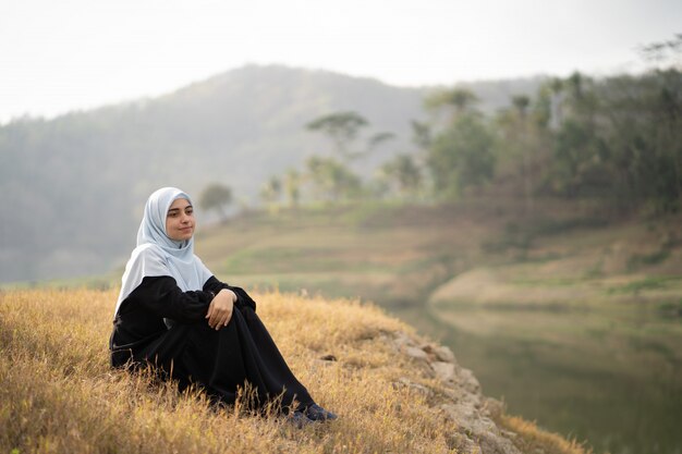 Woman with hijab sitting outdoor