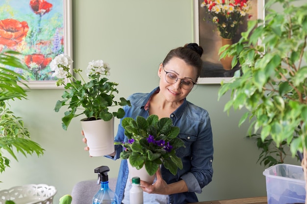 Woman with home plants in pots hobbies and leisure