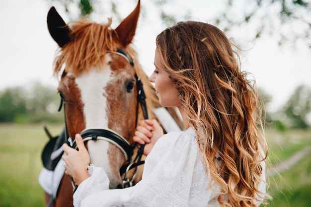 Woman with horse standing on field