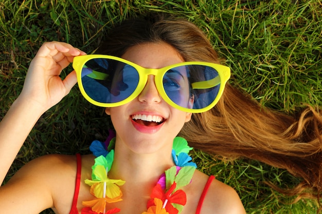 Woman with huge glasses and festival garland