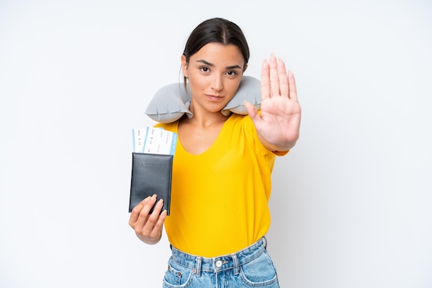 Photo woman with inflatable travel pillow over isolated background making stop gesture