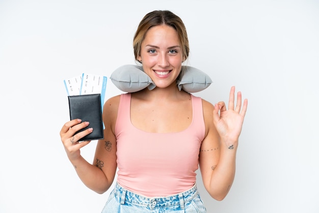 Woman with Inflatable Travel Pillow over isolated background showing ok sign with fingers