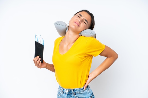 Woman with inflatable travel pillow over isolated background suffering from backache for having made an effort