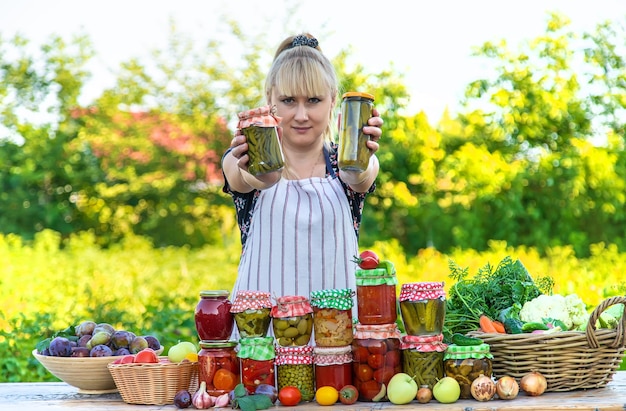 Woman with jar preserved vegetables for winter Selective focus