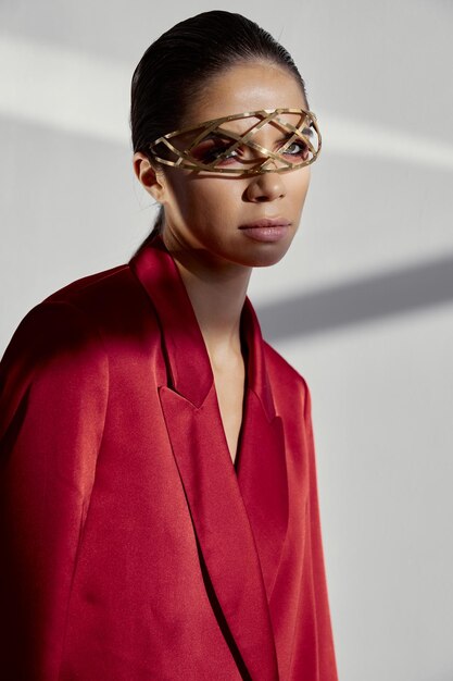 Photo woman with jewelry on her face and red jacket cropped view