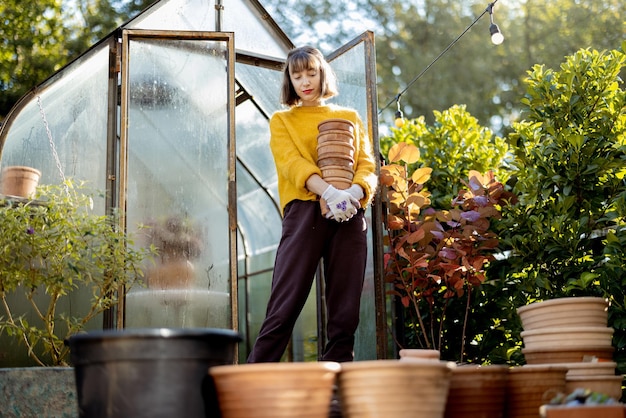 Woman with jugs in garden