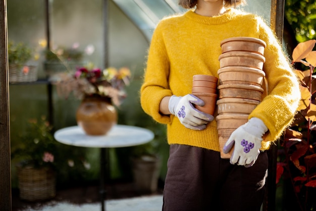 Woman with jugs in garden