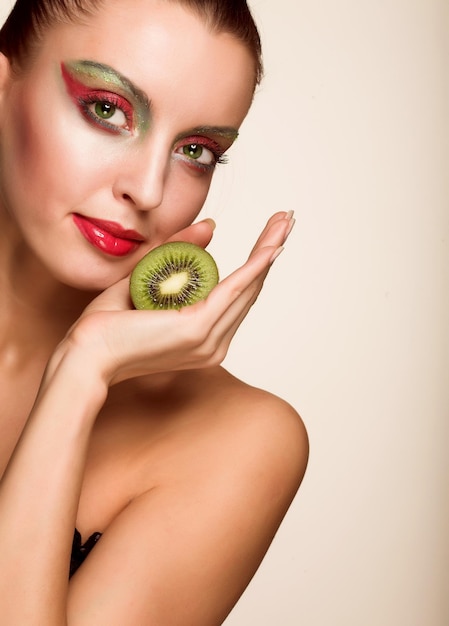 Woman with kiwi