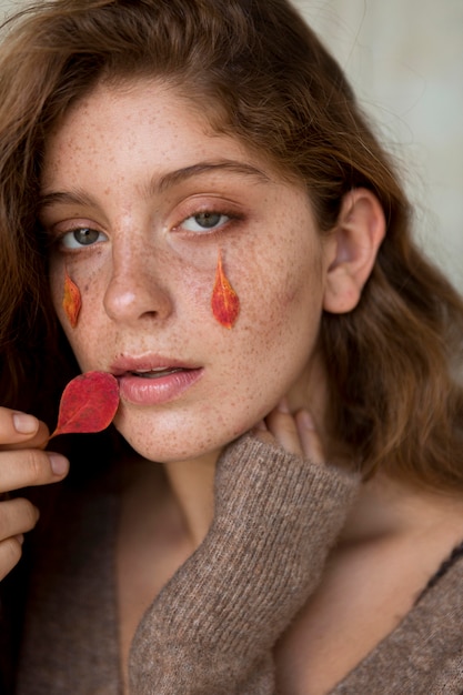 Woman with leaves on her face