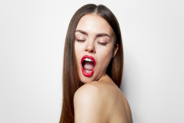 Woman with long Eyes closed mouth wide open bare shoulders hairstyle