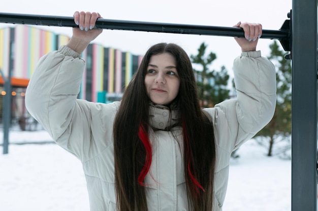 Woman with long hair holding onto a pole