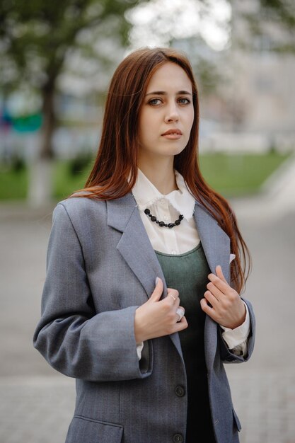 a woman with long hair is standing in a street