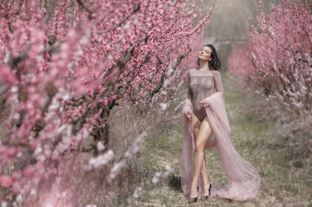 A woman with long legs walks through the garden with a catlike gait