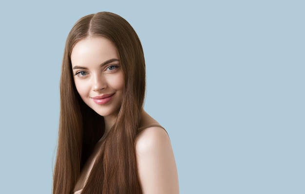 Woman with long smooth hair beautiful face happy. Color background. Blue