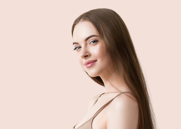 Woman with long smooth hair beautiful face happy. color background. pink