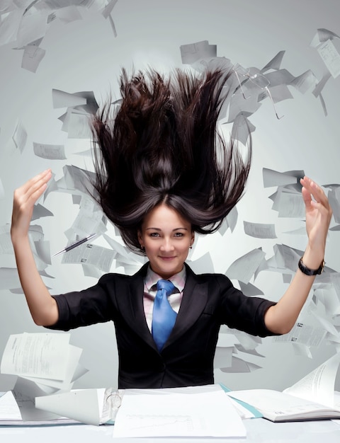 Woman with a lot of papers fliying