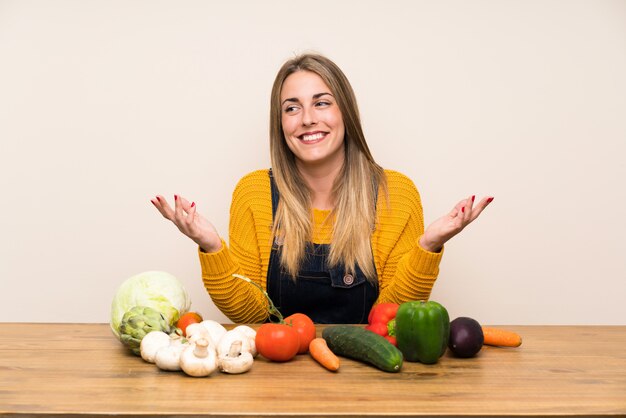 Woman with lots of vegetables laughing